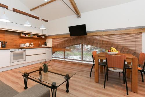 a kitchen and dining room with a table and chairs at Strawberry Line, Apartment 2 in Wells