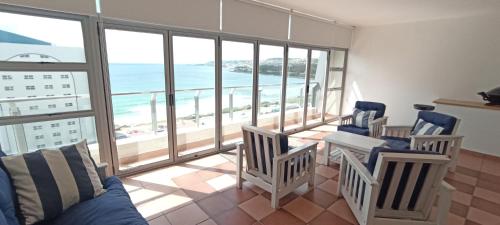 a living room with a view of the ocean at Vista Bonita Apartments in Mossel Bay
