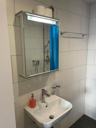 a bathroom with a sink and a mirror at Interlaken Apartments in Interlaken