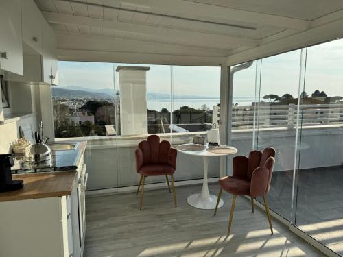 a kitchen with a table and chairs on a balcony at Maison 31 -Luxury Apartments in Santa Marinella