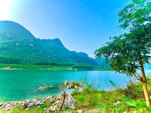 a view of a lake with mountains in the background at Little Rock Homestay in Phong Nha