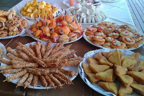 a table with many plates of food on it at Hotel Agostini in Bellaria-Igea Marina