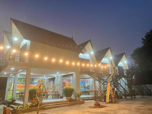 a building with lights on it at night at Little Rock Homestay in Phong Nha