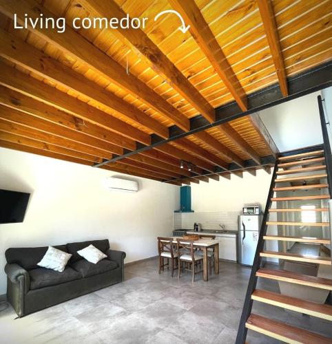 a living room with a couch and a table at Departamento los cardales in Los Cardales