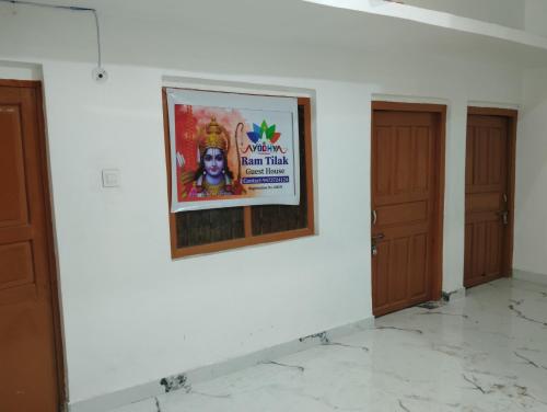 a poster on a wall in a room with two doors at Ram Tilak homestay in Faizābād