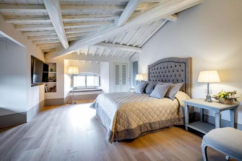 a bedroom with a bed and a table and a television at Villa S.Andrea in San Casciano in Val di Pesa