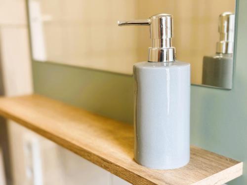 a white soap dispenser sitting on top of a counter at 59m² Ferienwohnung "Max" - direkt an der Erlebniswelt & Skiarena bis 4 Personen in Eibenstock