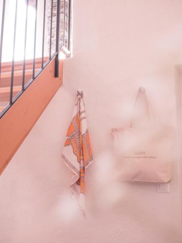 a bag hanging on a wall next to a window at B&B CCAA Ascona in Ascona