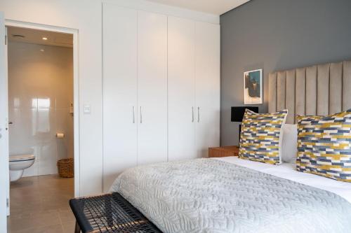a bedroom with a large bed and a bathroom at Oceans Umhlanga Accommodation in Durban