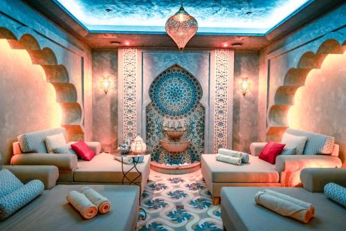 a living room with two couches and a fountain at Wellness & Spa Hotel Kaskady in Sliač