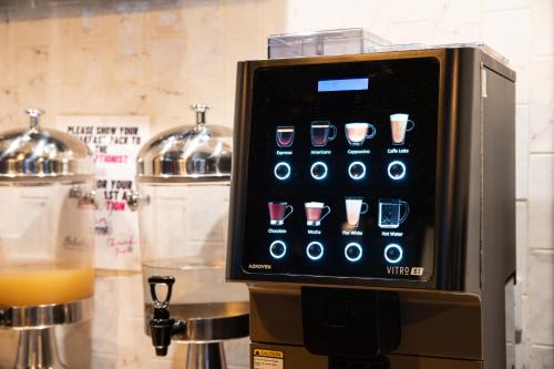 a coffee machine with a screen on top of it at Urban Nomad - Camden Town in London