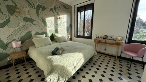 a bedroom with a bed with a flower patterned wall at Chambre Pivoine au Domaine de l'Aven in Villeneuve-Minervois