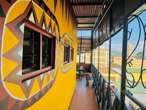 a yellow train with graffiti on the side of a building at Arusha Backpackers Hotel in Arusha
