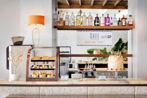 a bakery counter with a display of pastries at O2 Beach Club & Spa All Inclusive by Ocean Hotels in Christ Church