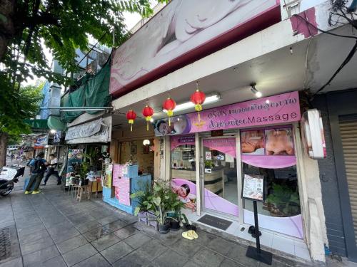 a store with a pink sign on the side of a street at 168 House 4A4B 350m BTS Krungton Buri near Icon Siam in Godown