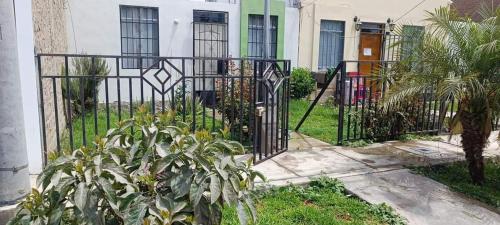 a black iron gate in front of a house at Villa del Sol de Ica in Ica