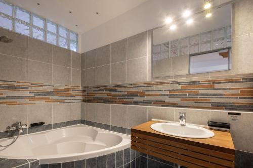 uma casa de banho com uma banheira e um lavatório em Pytloun Wellness Travel Hotel em Liberec