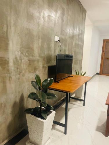 a desk with a computer on it in a room at Roya Khmer House in Siem Reap