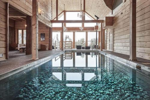 a swimming pool with rocks in the water at NoName Resort in Łapsze Niżne