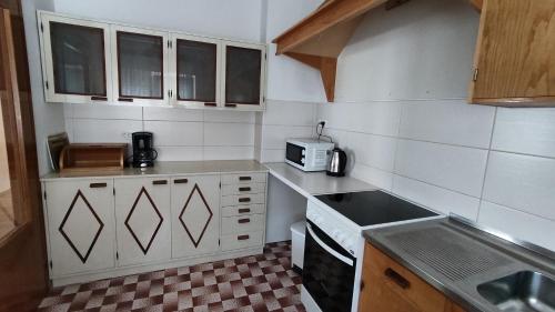 a small kitchen with a sink and a microwave at Apartment Marija Selce in Selce