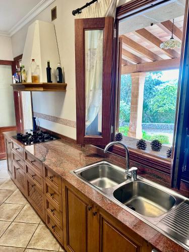 a kitchen with a sink and a large window at Finca Son Manxo (villas2meet Mallorca) in Manacor