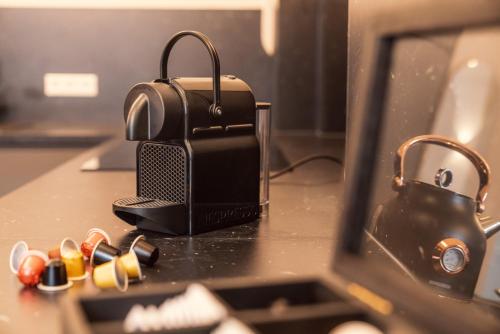 a briefcase sitting on a desk next to a laptop at NEW LUXUS Suite I TWO Kingbeds I Center in Augsburg