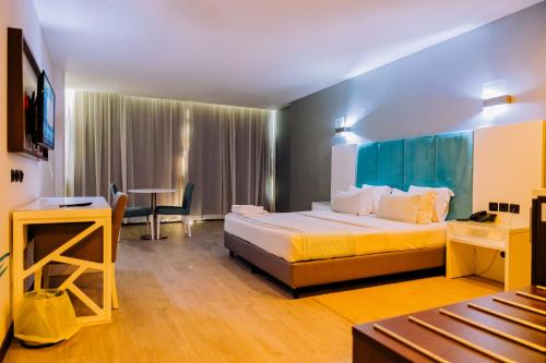 a hotel room with a bed and a desk at Beira Terrace Hotel in Beira