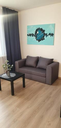 a living room with a couch and a table at 1izbovy byt v Banskej Bystrici in Banská Bystrica