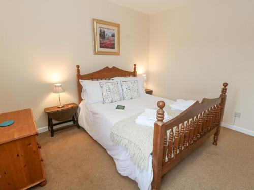 a bedroom with a large bed with a wooden headboard at Glyde House in Dorchester