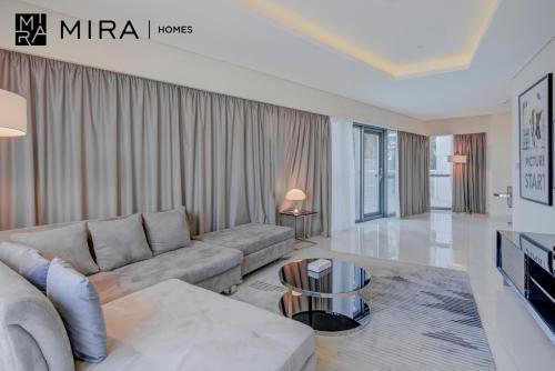 sala de estar con sofá y mesa en Mira Holiday Homes - Fully furnished 1 bedroom in Paramount en Dubái