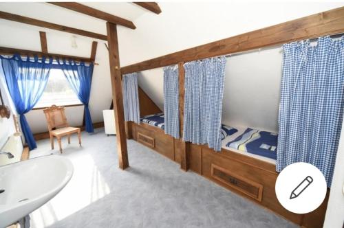 a bedroom with two bunk beds and a sink at Urlaubsoase und Meehr in Hage