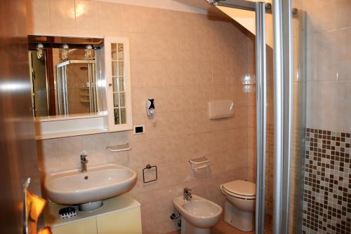 een badkamer met een wastafel, een toilet en een douche bij Casa Marina - Holiday Rental in Garda
