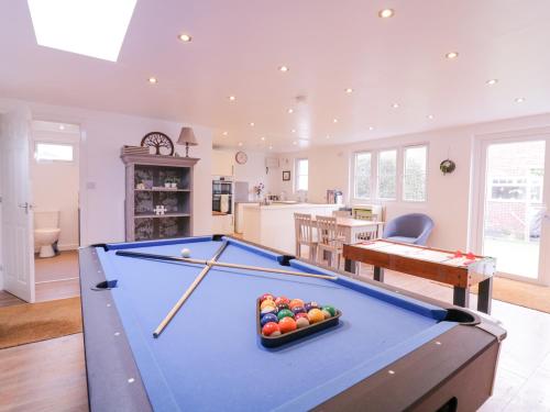 a pool table in a living room with at Hide and Sleep in Walton-on-the-Naze