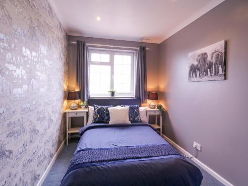 a bedroom with two beds and a window at Hide and Sleep in Walton-on-the-Naze