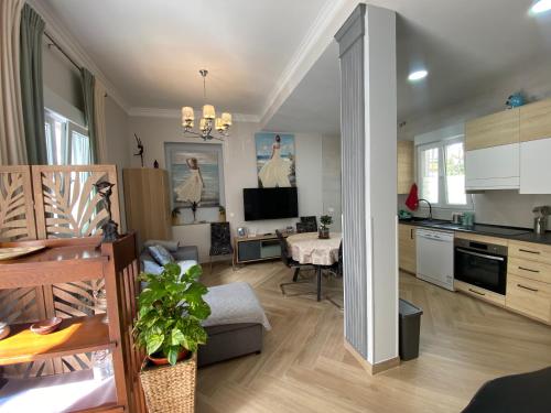 a living room with a kitchen and a dining room at Casa El Capitán in Málaga