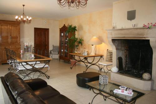 a living room with a couch and a fireplace at La Closerie des Sacres in Lavannes