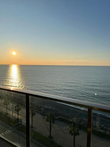 a view of the ocean at sunset from a balcony at SEA in Batumi