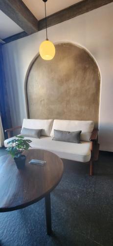 a living room with a couch and a table at Kave Hotels - Pondicherry in Puducherry