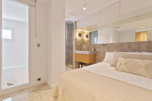 a bedroom with a large bed and a sink at Las Terrazas de Santa Clara in Marbella