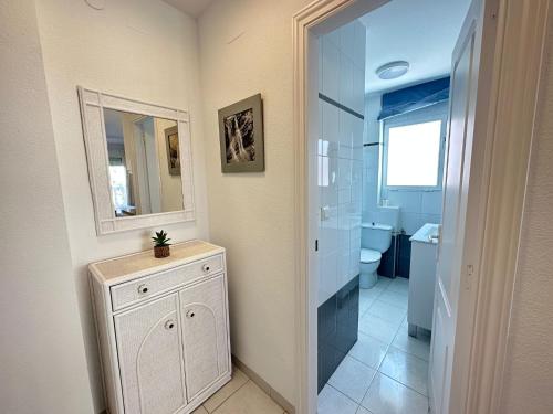 a bathroom with a sink and a toilet and a mirror at PLAYA Denia BEACH ESTUDIO in Denia