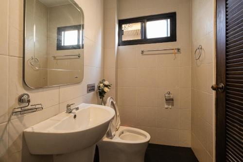 a bathroom with a sink and a toilet at Tawang Home in Chiang Mai