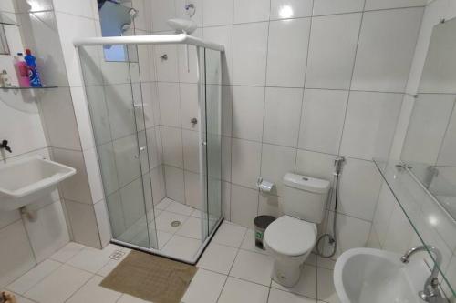 a bathroom with a shower and a toilet and a sink at Apartamento em Stella Maris in Salvador