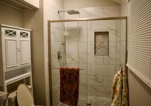 Amazing 3 BD Apartment In Mid West في نيويورك: دش مع باب زجاجي في الحمام