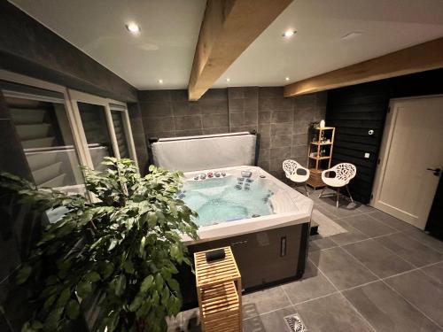een badkamer met een bad met een potplant bij B&B Eindeloos in Opeinde