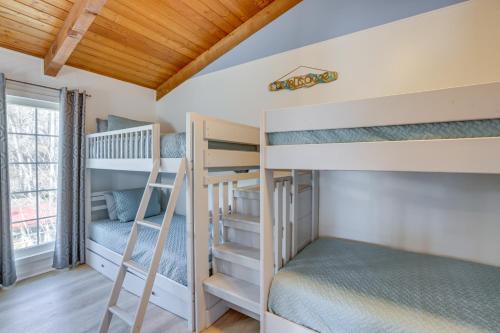 a bunk room with two bunk beds and a window at Waterfront Shelby Home with Fireplace and Scenic Decks in Shelby