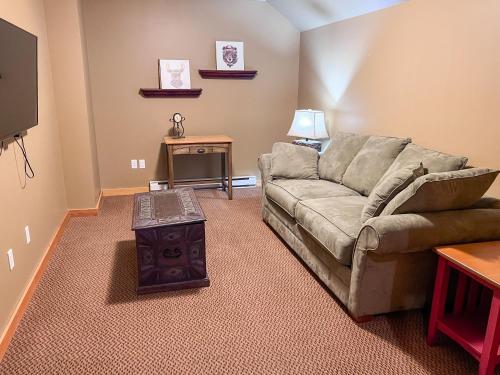 a living room with a couch and a table at Pinnacle Ridge Condos by Fernie Central Reservations in Fernie