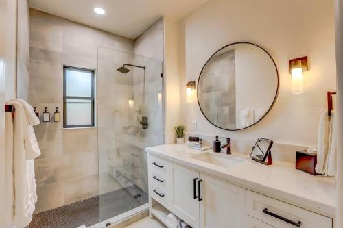 a bathroom with a sink and a shower with a mirror at Sam Hughes Desert Oasis, Private Pool & Walk to UA in Tucson