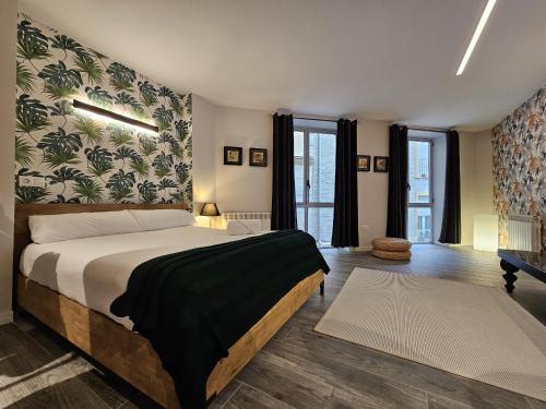 a bedroom with a large bed and some windows at TuApartamento Loft - Fuente de Navarrería in Pamplona