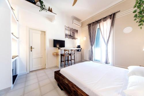 a bedroom with a large bed and a window at B&B Camera a Sud Iris in Trani