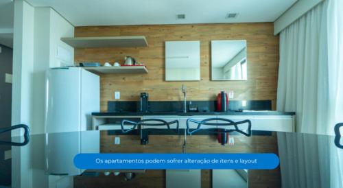 a kitchen with a table and two chairs in it at Roomo Transamerica Recife Boa Viagem in Recife